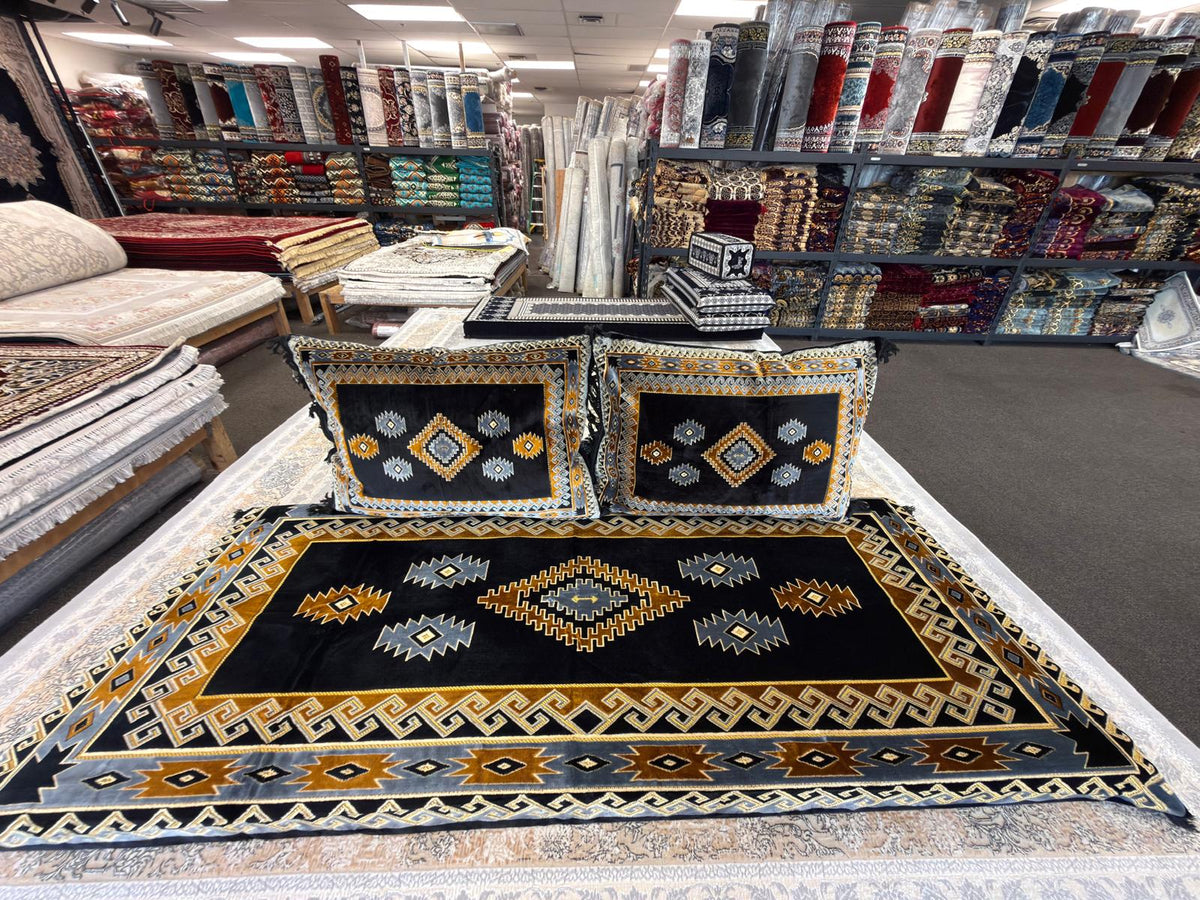 Black and gold tribal diamond Afghan toshak and matching cushions in the Stylish Rugs showroom, Sacramento