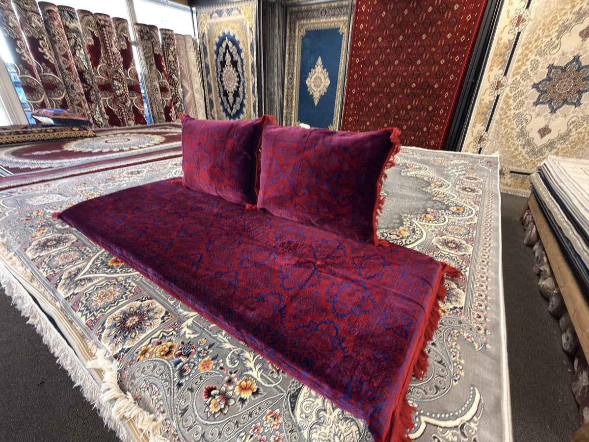 Burgundy toshak cushions and mattress cover, angled view