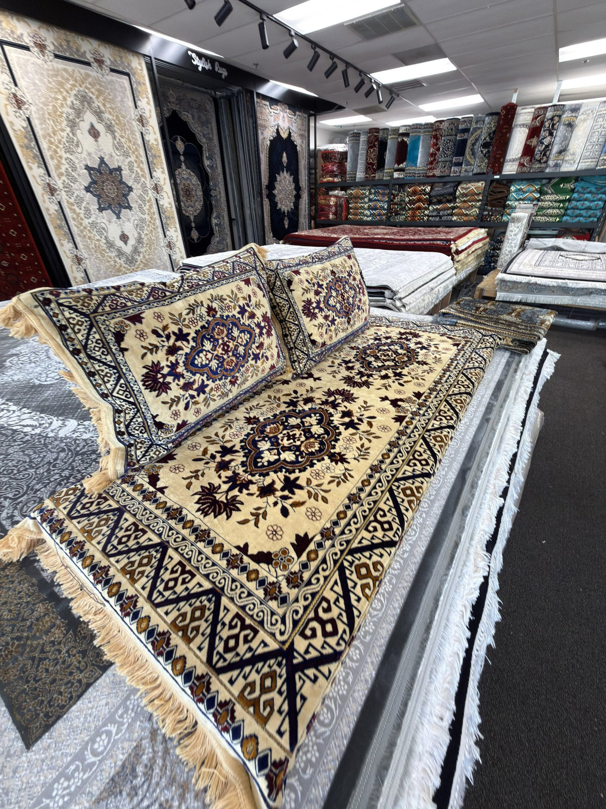 Cream and navy kilim-border Afghan toshak cover set in the Sacramento showroom