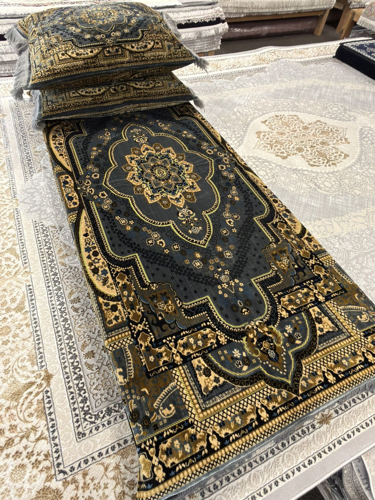 Dark teal Afghan toshak with gold medallion and matching cushion covers