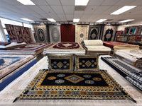 Black Afghan toshak cover with gold and grey stepped diamond medallion, detail view