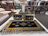 Black and gold tribal diamond Afghan toshak and matching cushions in the Stylish Rugs showroom, Sacramento