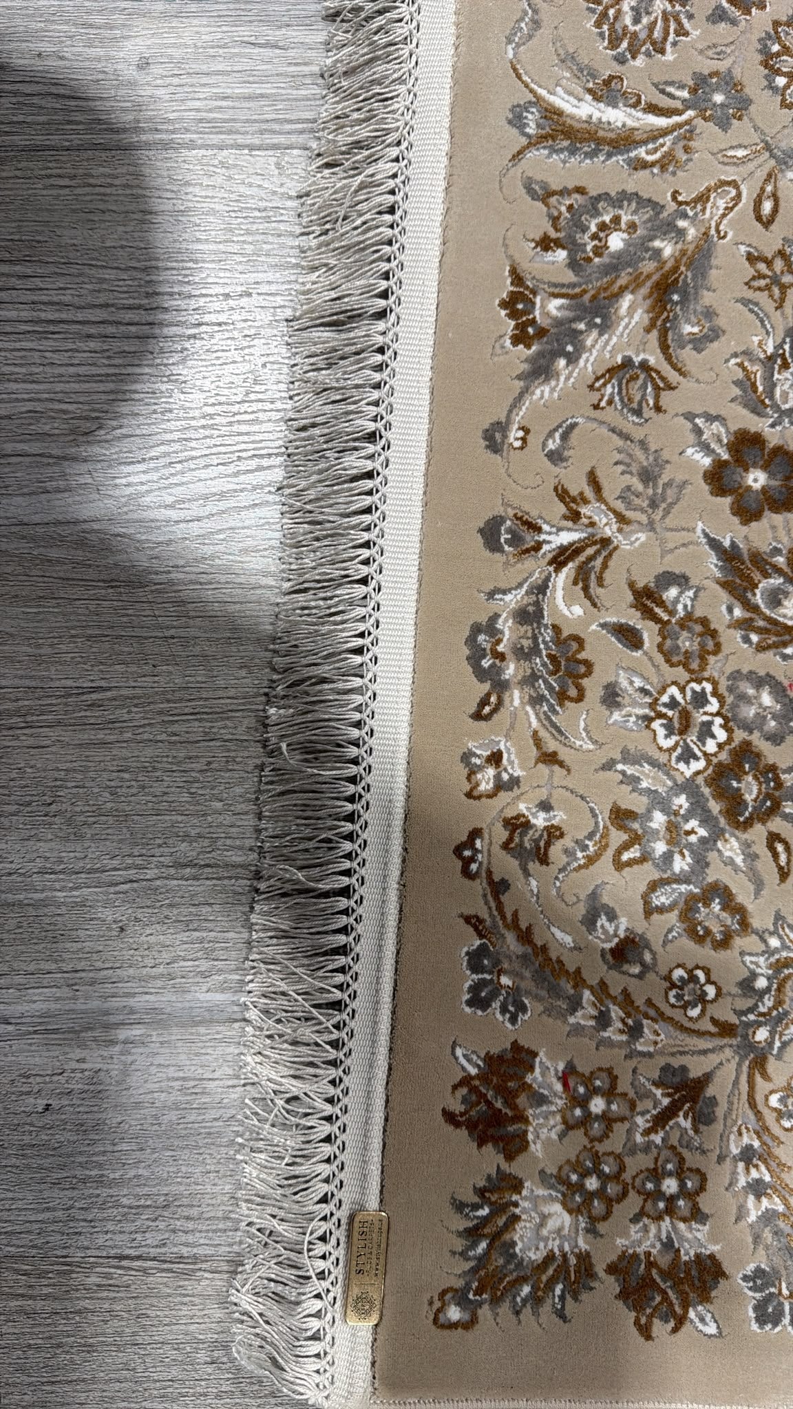 The hand-made fringe and the Stylish Rugs and Carpets label stitched to the edge of the rug