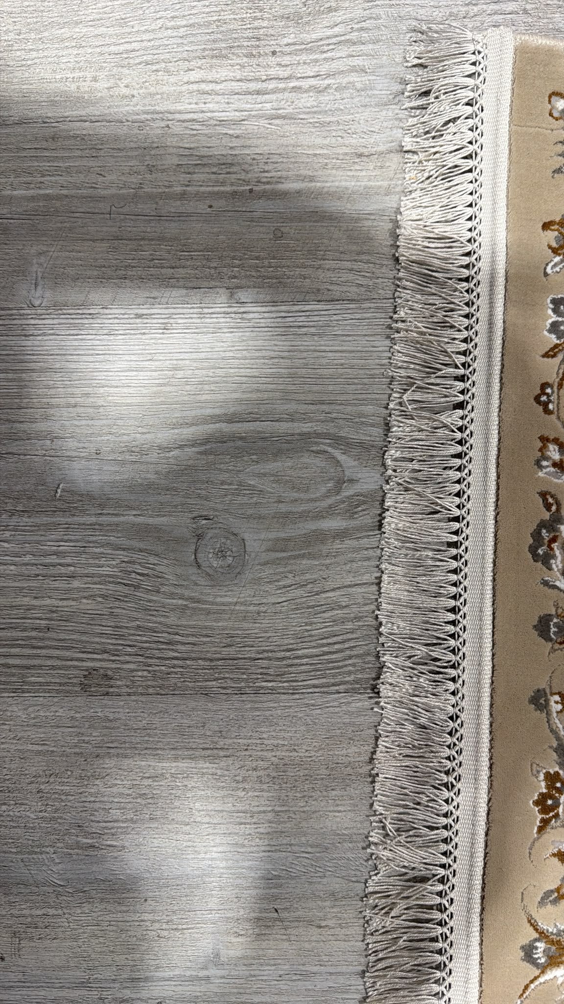 Close-up of the hand-made fringe, knotted into a braided band along the end of the rug