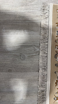 Close-up of the hand-made fringe, knotted into a braided band along the end of the rug