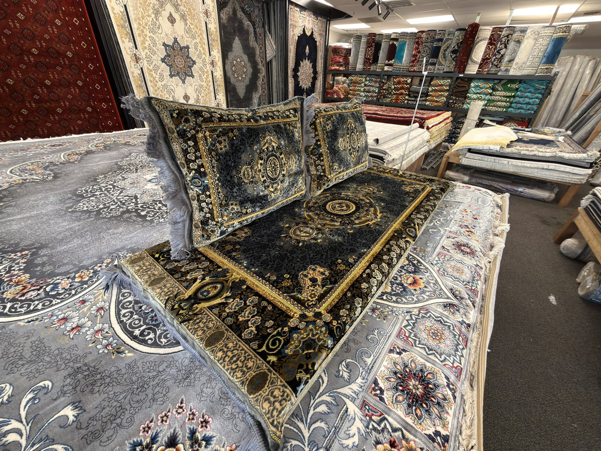 Black and gold floral medallion toshak cushions and mattress cover, angled view