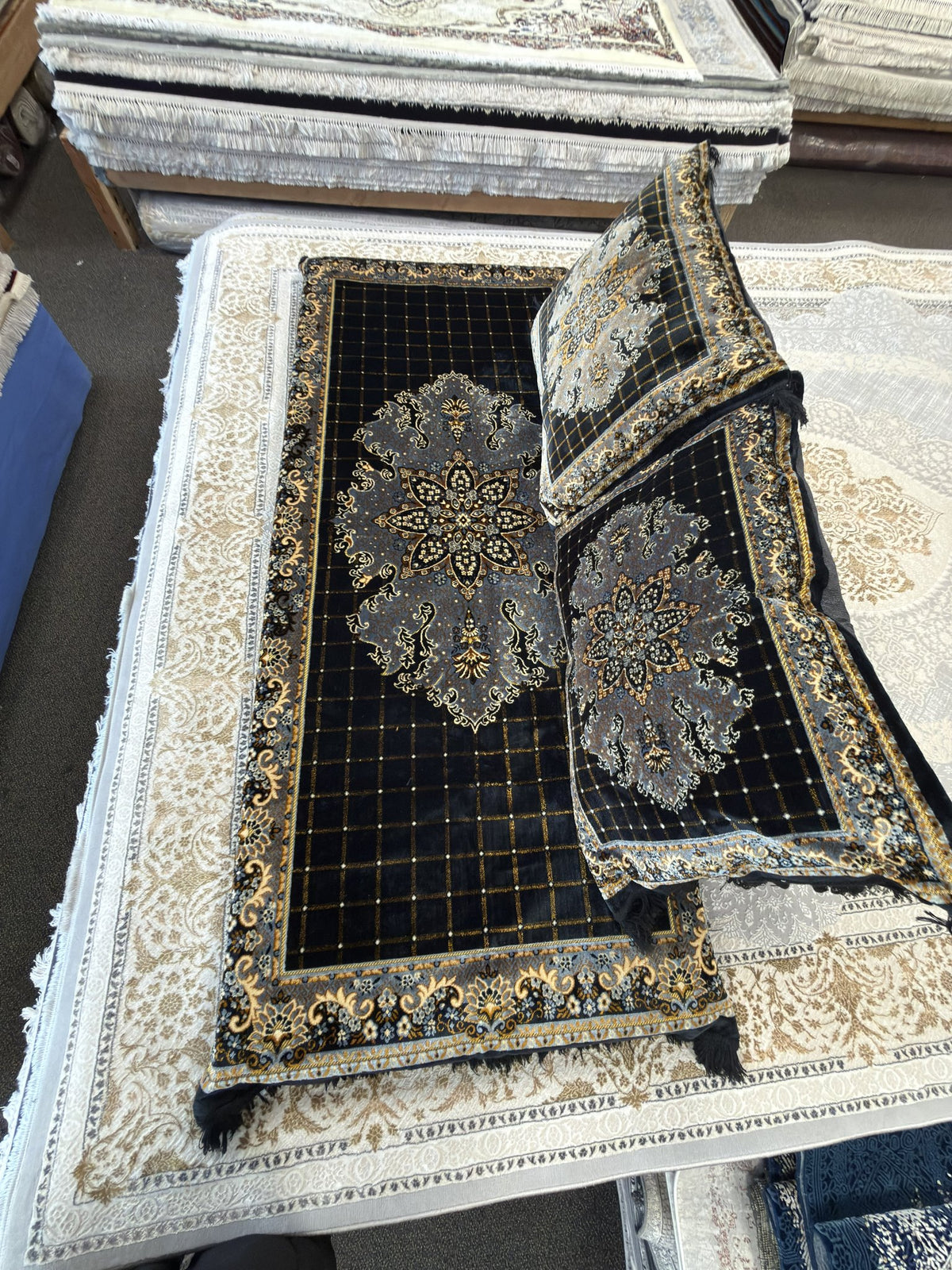 Afghan toshak floor mattress cover laid flat, black trellis field