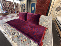 Burgundy toshak cushions and mattress cover, angled view