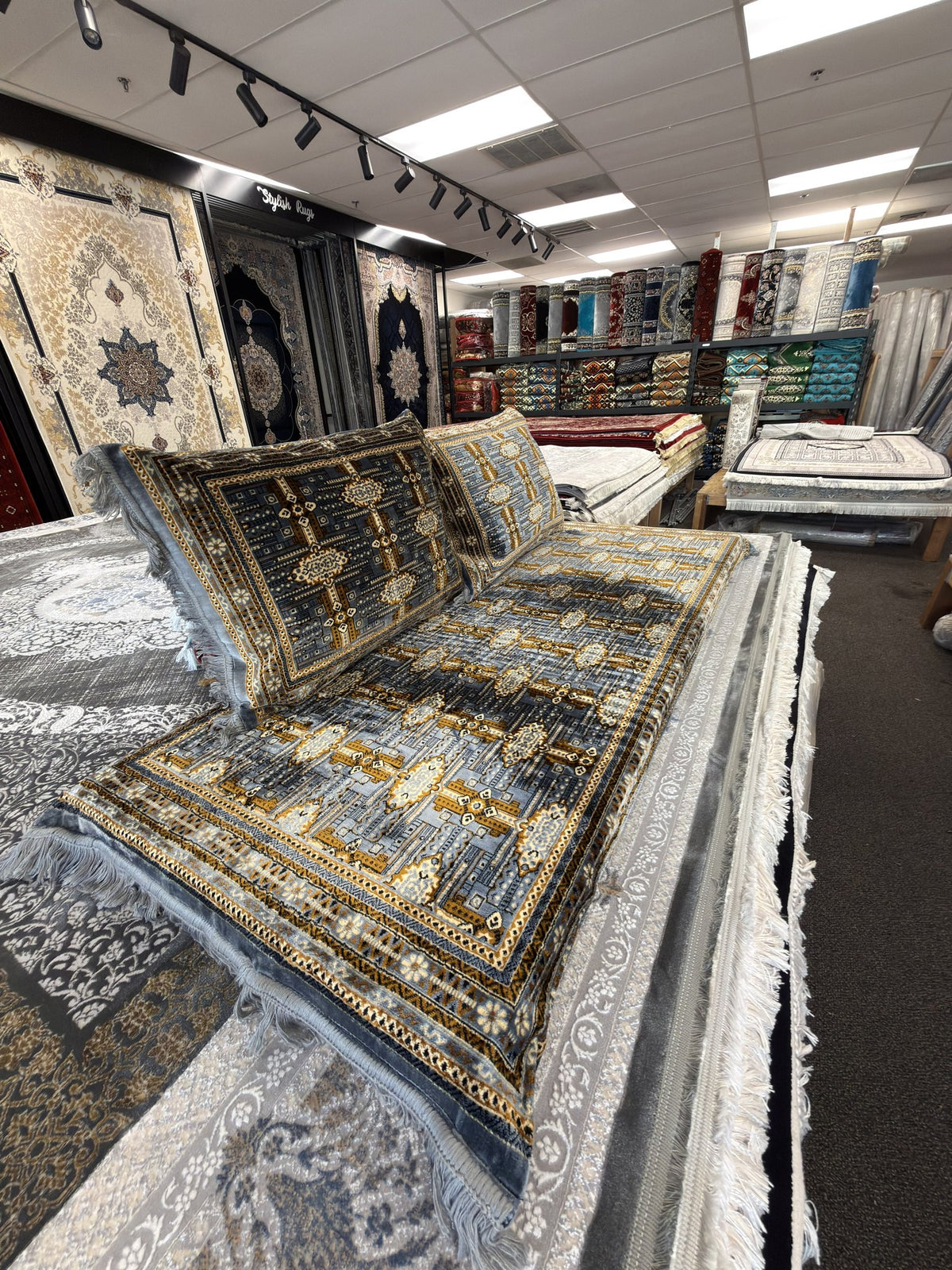Grey and gold panel Afghan toshak cover set in the Sacramento showroom