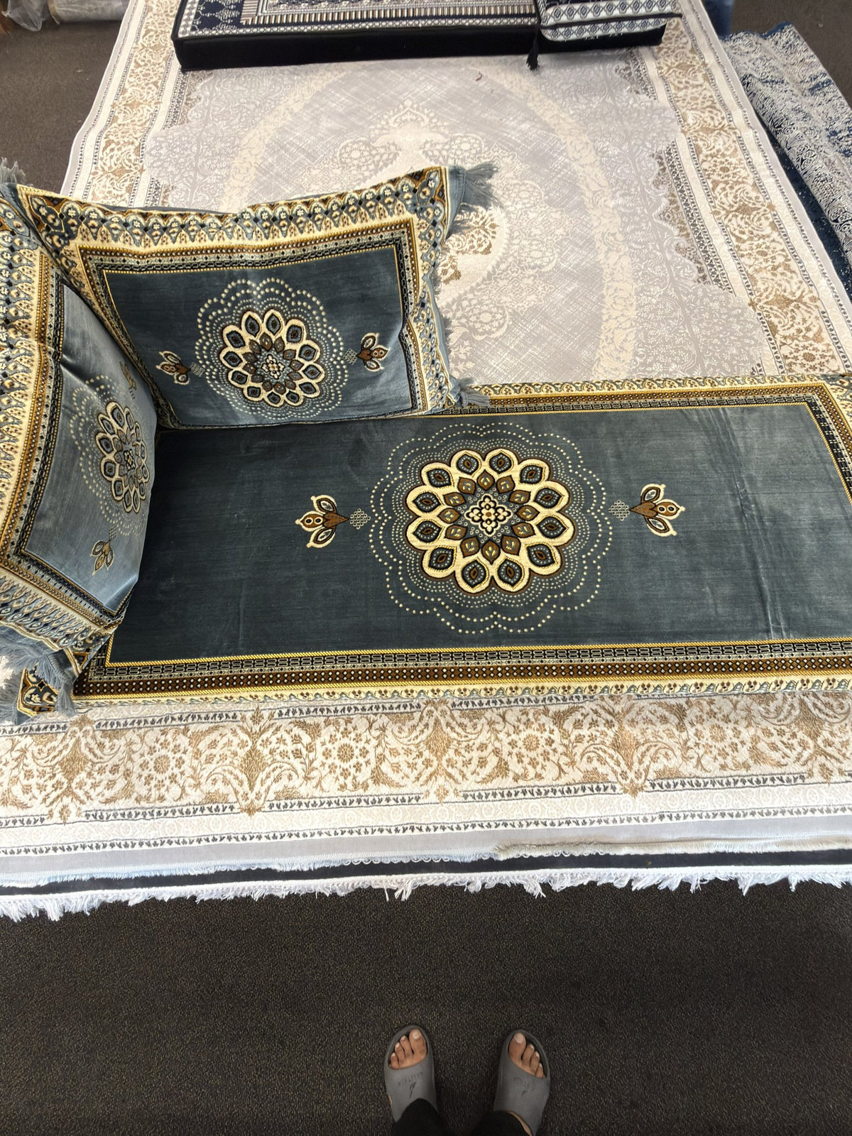 Gold rosette medallion detail on a sage grey Afghan toshak cover