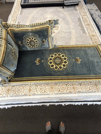 Gold rosette medallion detail on a sage grey Afghan toshak cover